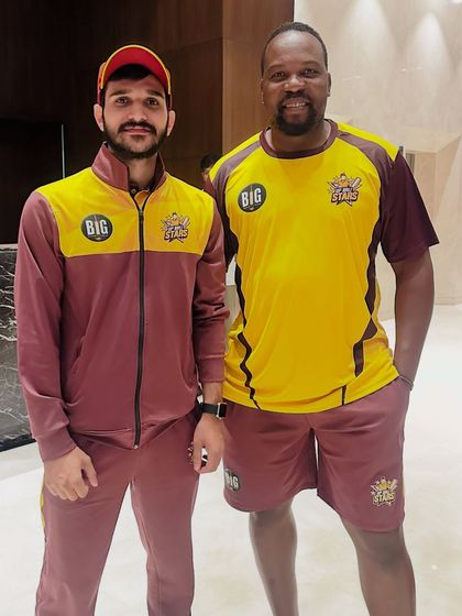 With a fellow athlete from the Big Cricket League. My work involves being on the ground with the teams, providing immediate support and therapy.