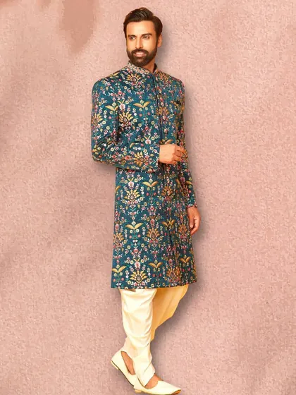 This teal sherwani with multi-colored floral embroidery is a true statement piece. It’s perfect for a groom or wedding guest who wants to stand out.