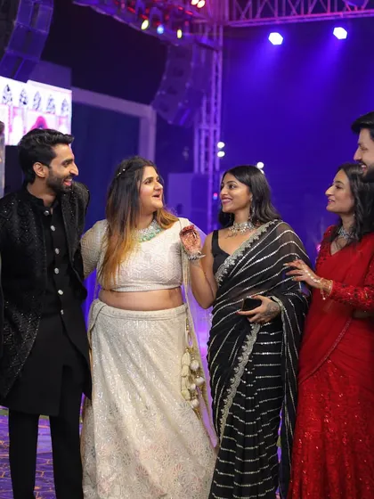 Candid moments on the dance floor are the best. Here I am, sharing a laugh with friends at a wedding reception, all of us in our festive best.