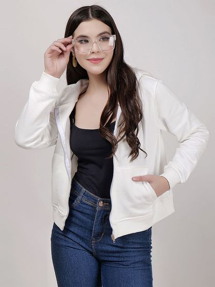 A clean studio shot of a model in a white zip-up hoodie and jeans, perfect for showcasing basic apparel essentials.