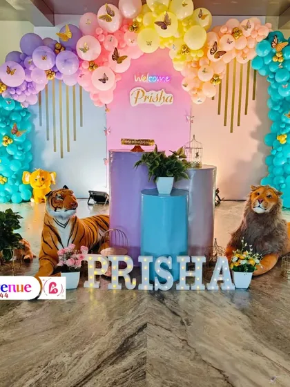 A unique butterfly jungle theme for Prisha's welcome party. This grand setup combines pastel rainbow balloons with large animal props for a truly imaginative entrance.