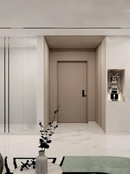 An entryway concept for the Gulecha Residence, where art and architecture merge. A niche for a statement sculpture and a gallery wall for photographs personalize the space, while a fluted glass partition offers a hint of the rooms beyond.