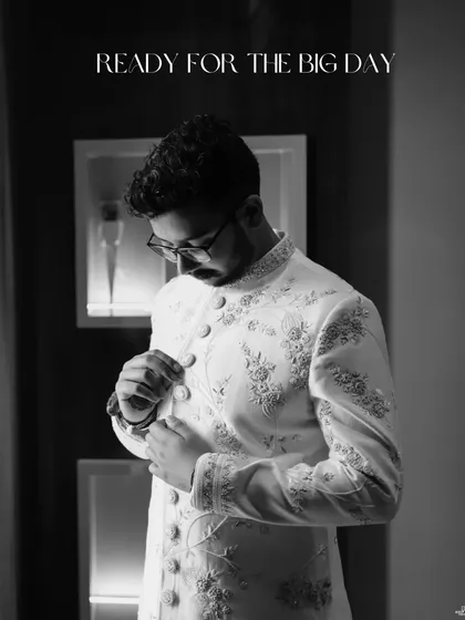 The groom's story is just as important. This black and white portrait captures a moment of quiet reflection and style as he prepares for the big day, highlighting the fine details of his sherwani.