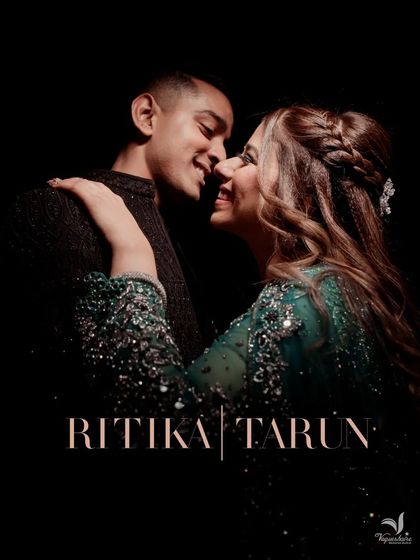 A dark and intimate portrait of the couple, their faces close, beautifully lit to highlight their connection.