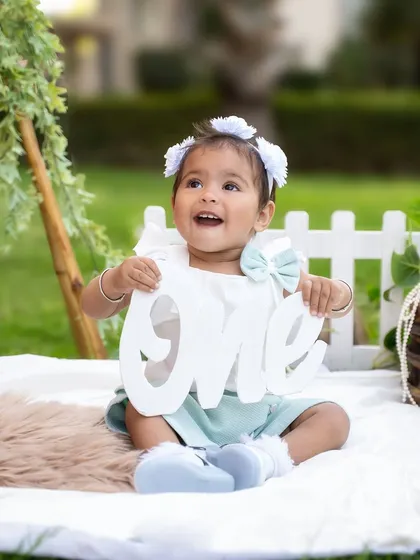 Proudly holding her "one" sign, this little girl is the star of her outdoor birthday shoot. I love capturing these milestone markers in a natural, candid way.