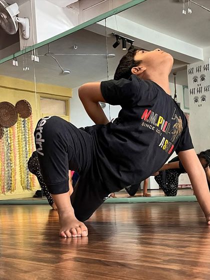 A student strikes a dynamic pose during a class, showcasing his flexibility and control. Random shots like these often capture the beauty of movement in training.