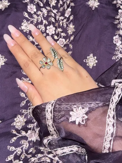 A detail shot of my hand, showing off a beautiful floral ring that complements the embroidery on the suit.
