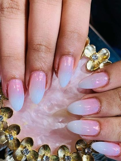 A beautiful pink and blue "aura" or ombre effect on almond-shaped nails, giving a soft, airbrushed appearance.
