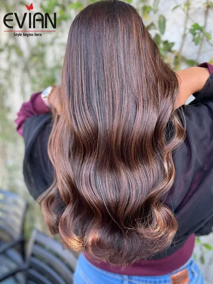 A gorgeous example of a rich brunette balayage. The mix of chocolate and caramel highlights adds incredible depth and shine, especially when styled into these loose, flowing waves.