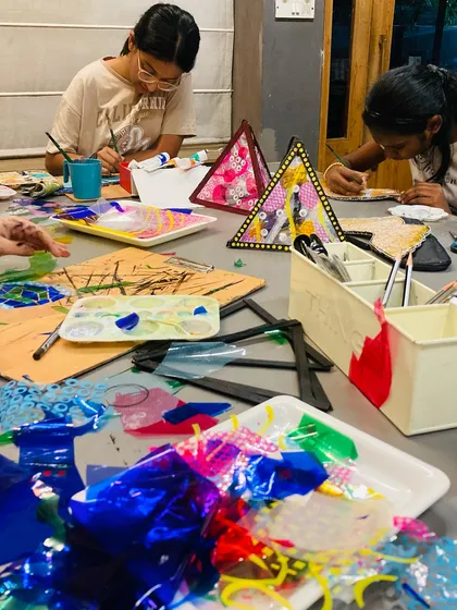 A busy table during our Diwali lantern making session. Students are focused on painting and assembling their unique, festive decorations.
