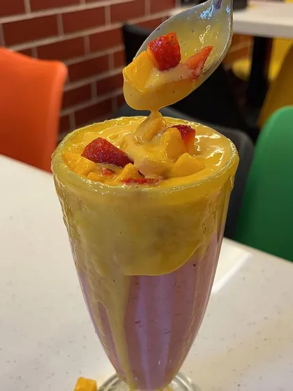 A spoonful of my Mangoberry milkshake, showing the rich and creamy texture of the drink.