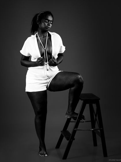 A full-body black and white shot from a conceptual series, creating a statuesque and artistic image.