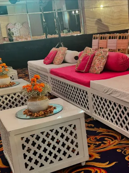 Low seating arrangement with traditional block-print cushions and marigold centerpieces, creating an authentic and comfortable space for guests.