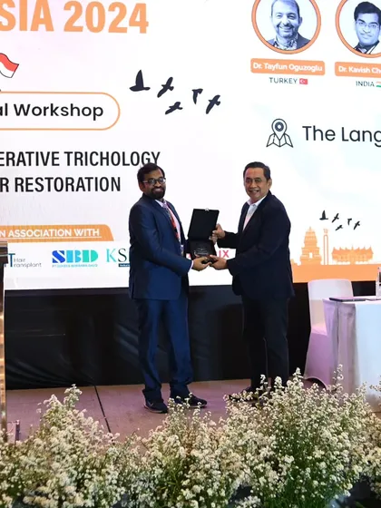Receiving a token of appreciation from the Chairman of PERDOSKI during the FUEASIA Indonesia workshop.