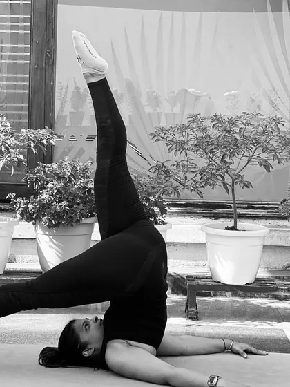 This is a variation of a shoulder stand, an inversion that helps calm the nervous system and improve circulation. We work on building the strength for these poses safely in my classes.