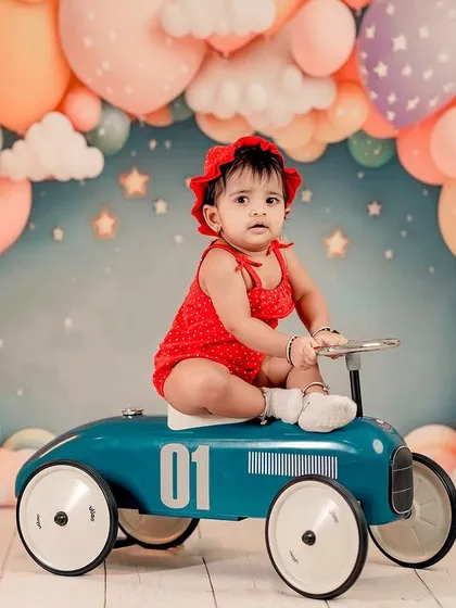 A dreamy setup for a little doll. We use colorful backdrops and fun props like this vintage toy car to bring your child's imagination to life in the studio.