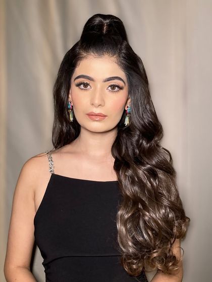 A frontal view of this gorgeous half-up ponytail hairstyle. It's a versatile look that works beautifully for bridesmaids, guests, or even a bride for her cocktail party.