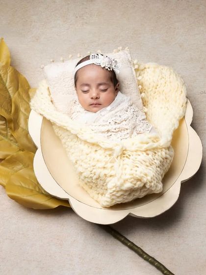 Contagious cuteness alert! This sweet baby, nestled in a flower-shaped bowl, is the picture of peaceful slumber.