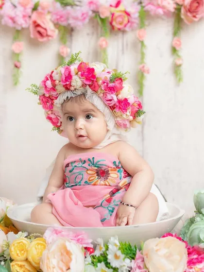 A little doll in a floral paradise. This 'milk bath' style shoot with flowers is a beautiful and unique way to capture a baby's portrait.