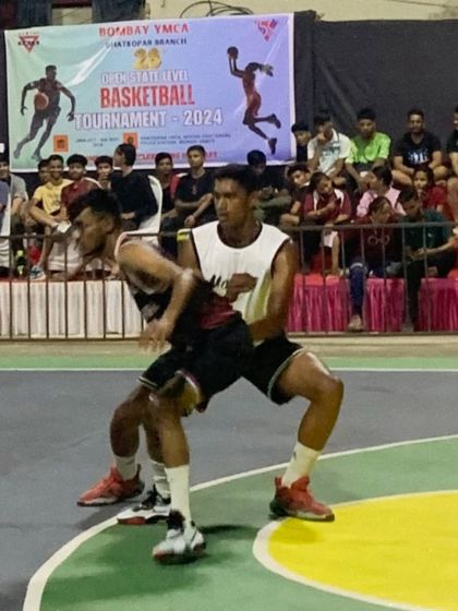Locked in on defense. Two players battle for position in a crucial moment during the Bombay YMCA basketball tournament.