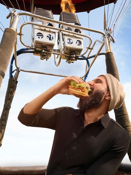 It's all about the bite. A close-up shot for the KFC campaign with Vijay Deverakonda, where the simple black shirt and beanie keep the focus on him enjoying the product.