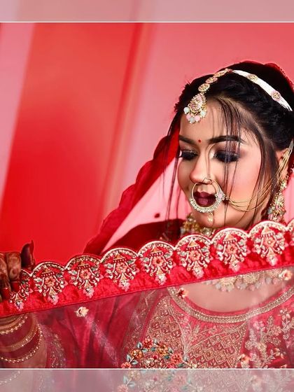 A bridal portrait where the bride is looking down through her embroidered veil, creating a sense of anticipation and elegance.
