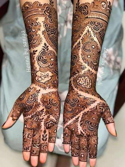A unique Eid design with a "vine" or "bail" style that spreads across the hands, incorporating Arabic calligraphy.