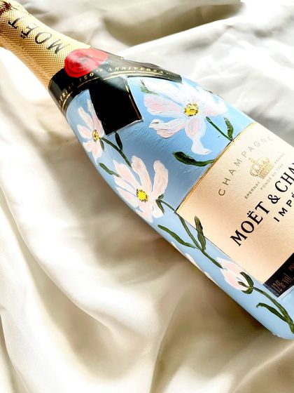 While I don't engrave champagne bottles due to the pressure, I love to paint them. This Moët & Chandon bottle is covered in a beautiful light blue with delicate white cosmos flowers.