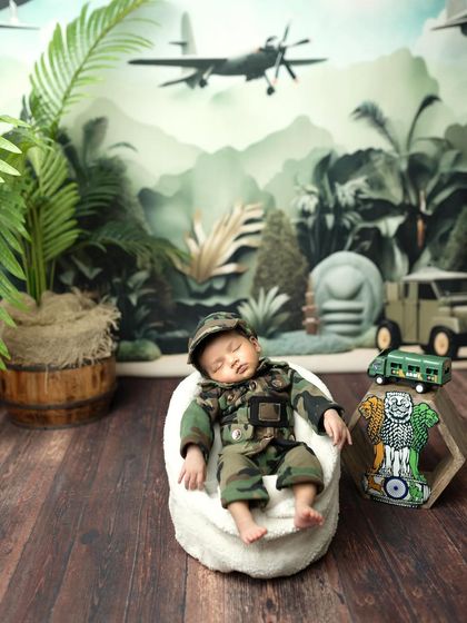 A wider view of the army-themed setup, showing the jungle backdrop, miniature jeep, and other props that bring this creative concept to life.