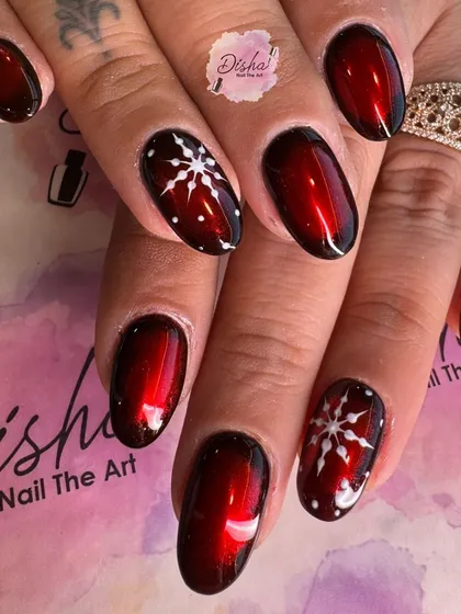 A beautiful Christmas design with a deep red cat eye base and hand-painted snowflakes. It's both festive and elegant.