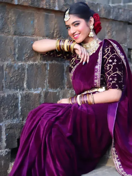 A relaxed and happy portrait of the bride, seated and smiling.