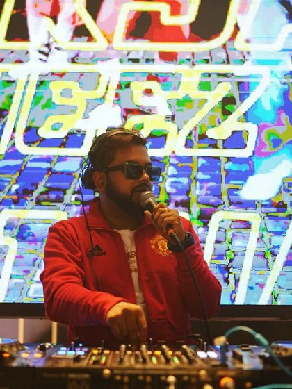 I work hard in silence and let my success make the noise. A great shot of me on the mic with vibrant visuals in the background.