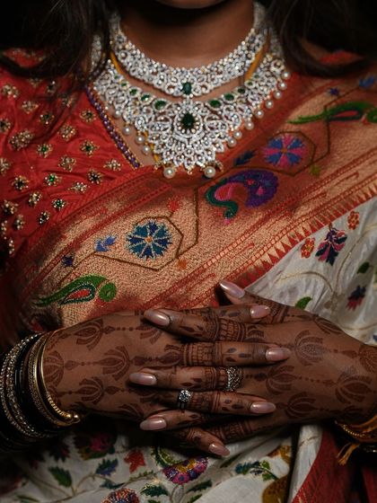 A stunning photo where the deep mehendi stain is the highlight. It perfectly complements the bride's traditional saree and jewelry.
