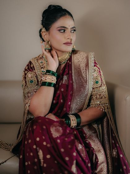 The complete look is an ode to fierce femininity and sacred tradition. The makeup is designed to bring out her inner Maharani, making her feel confident and beautiful.