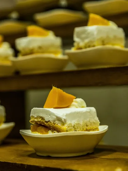 Mini mango mousse cakes, perfectly portioned and arranged for easy serving. A light and tropical dessert option that is always a crowd-pleaser.