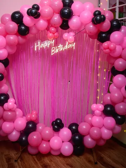 A chic and modern black and pink theme. The contrasting colors create a bold and stylish backdrop for any celebration.