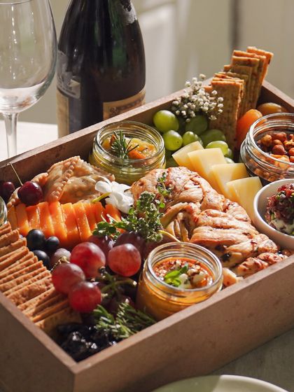 A beautifully arranged Cheese & Dip Grazing Box, perfect for a Rakhi celebration or any intimate gathering. It's a complete party in a box, designed to impress your guests.
