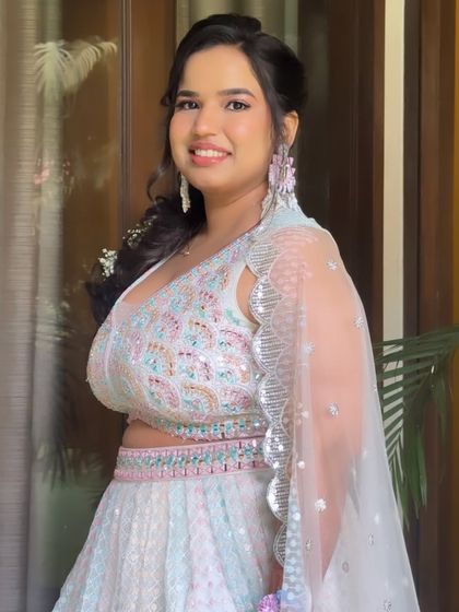 A radiant smile from this Haldi bride. The soft, glowing makeup perfectly complements her unique pastel lehenga.