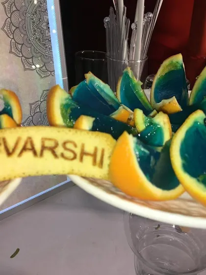 A close-up of the custom edible garnishes I provide. This cookie with the wedding hashtag 'VARSHI' adds a unique and delicious touch to the cocktails. (This image is the same as 61).