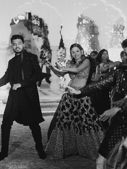 The party doesn't stop on stage. This shot captures the couple and their friends enjoying a dance on the floor, showing the infectious energy of the celebration.