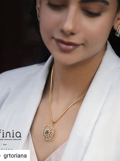 A closer look at the styling for GRT Oriana. The emerald pendant and earrings stand out beautifully against the white blazer and satin blouse, showcasing a powerful and elegant workwear combination.