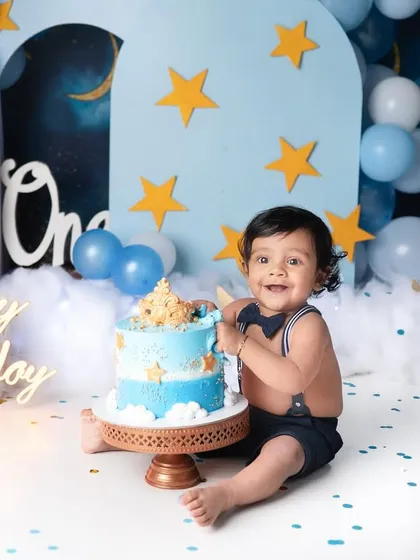 Nothing says "Happy First Birthday" like a cake smash! This little guy had the best time with his starry night themed celebration, and his joyful smile says it all.