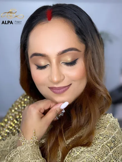 A detailed shot of the eye makeup, with a clean winged liner that lifts and defines the eyes.