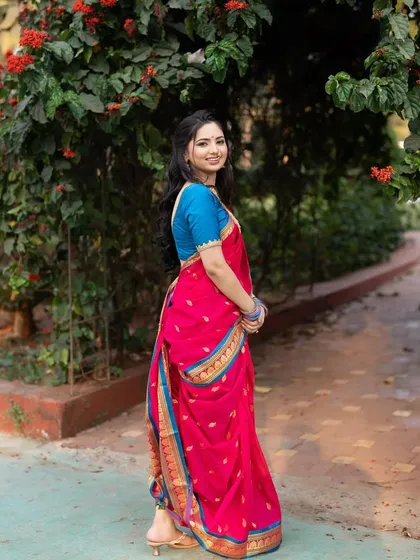 A full-length view of the bride's stunning Paithani saree. The vibrant colors and traditional drape are a testament to Maharashtrian heritage.