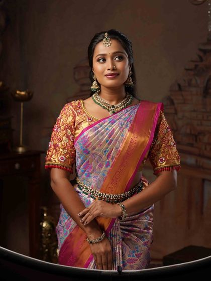 A closer look at the draping and styling for Ramya. The pallu is set perfectly to show off the intricate blouse work, and the pleats are neat, making it a comfortable yet glamorous look.