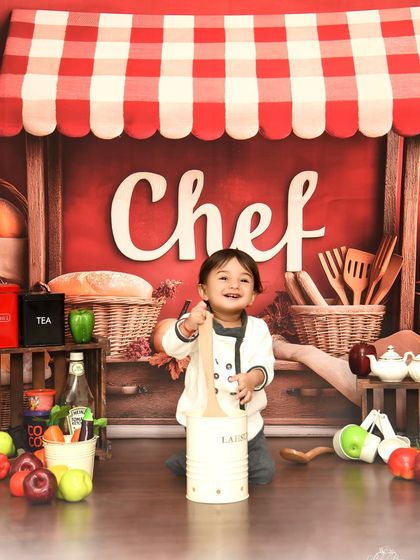 A close-up of our happy little chef. His infectious smile shows just how much fun a themed photoshoot can be.
