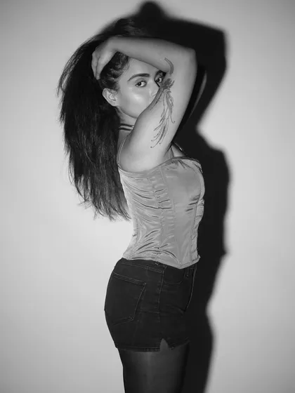 A confident, edgy pose. This black and white shot captures the "bad behaviour" spirit of my events. It's about being unapologetically yourself.