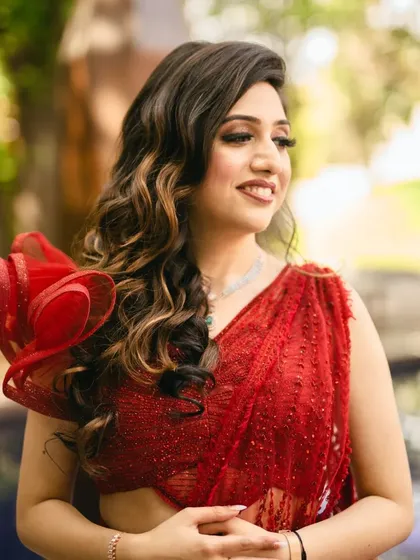 A close-up of the bride's soft, glamorous makeup. The look features gentle waves in her hair and a radiant complexion.