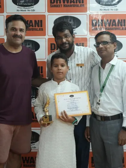 A student, his family, and teachers celebrating his success at the award ceremony.
