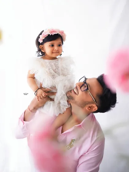 Shoulder rides from dad always bring the biggest smiles. A joyful father-daughter moment.